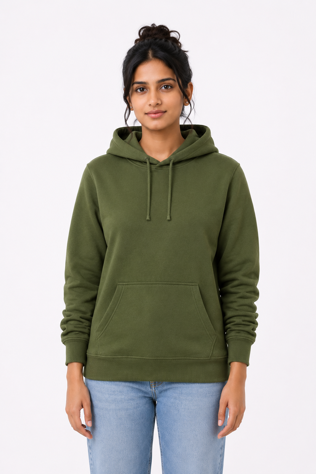 A woman wearing an olive green pullover hoodie with drawstrings and a front kangaroo pocket, paired with light blue jeans, standing against a plain white studio background.