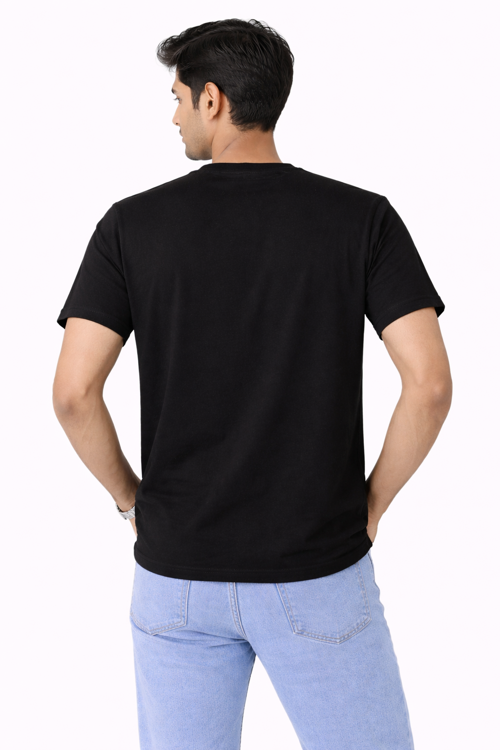 Person wearing a black t-shirt and light blue jeans on a white background