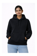 Person wearing a black hoodie and light blue jeans on a white background