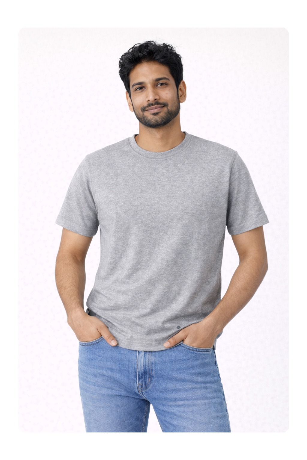Man wearing a gray t-shirt and blue jeans on a white background
