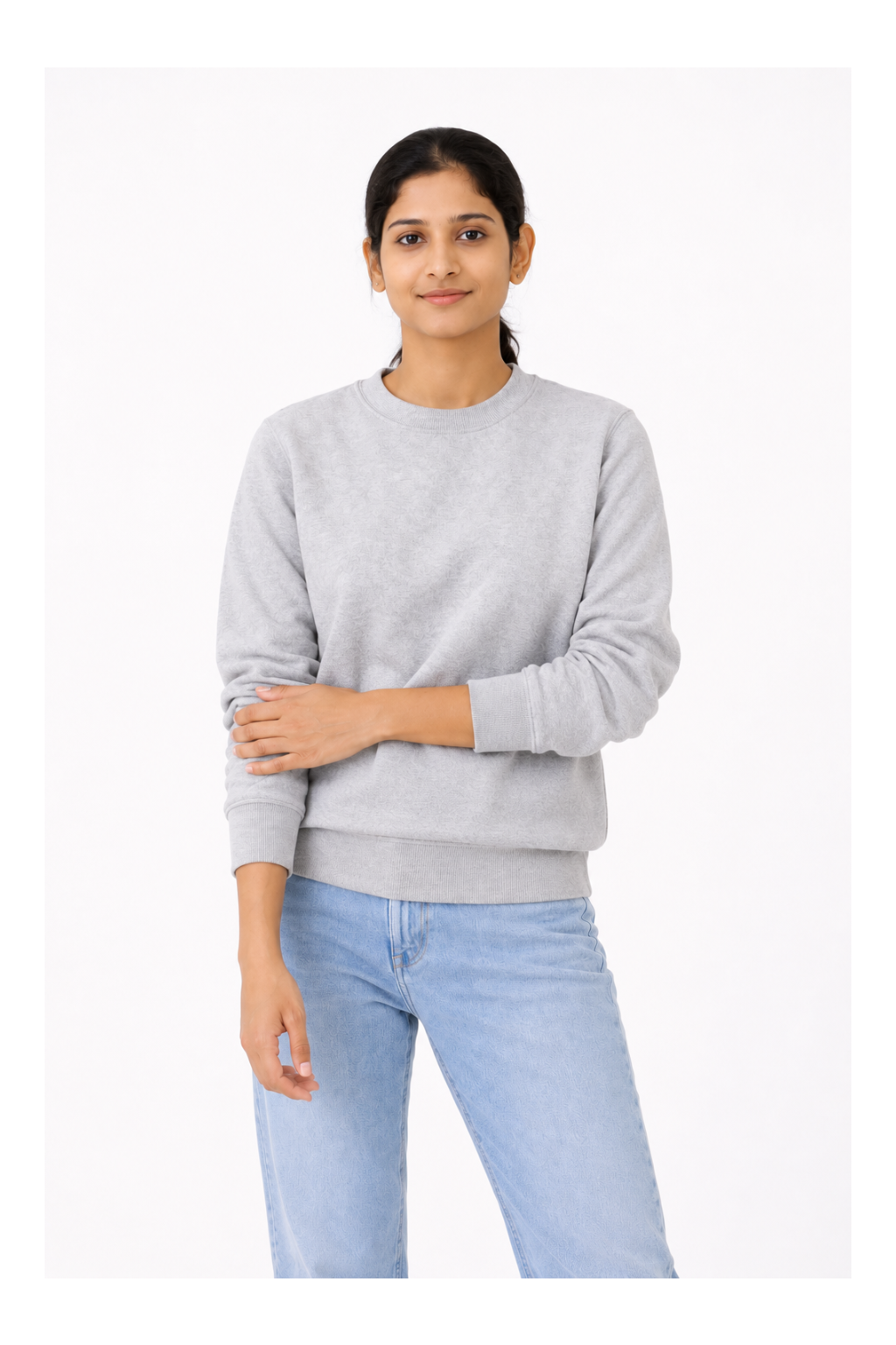 Person wearing a gray sweatshirt and light blue jeans on a white background