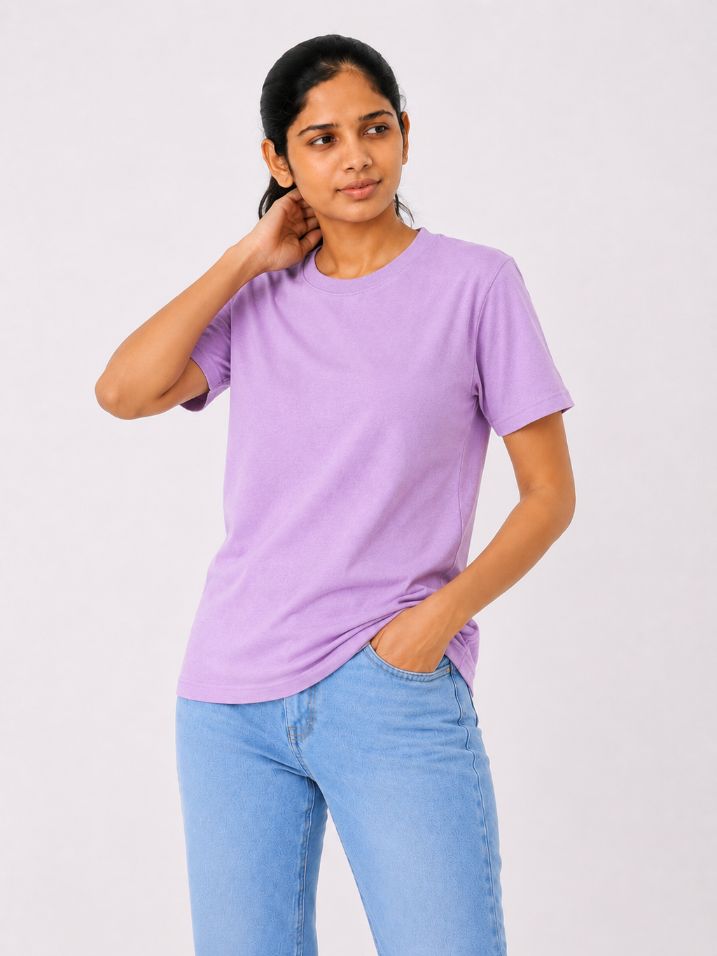 Person wearing a purple t-shirt and blue jeans on a white background