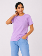 Person wearing a purple t-shirt and blue jeans on a white background
