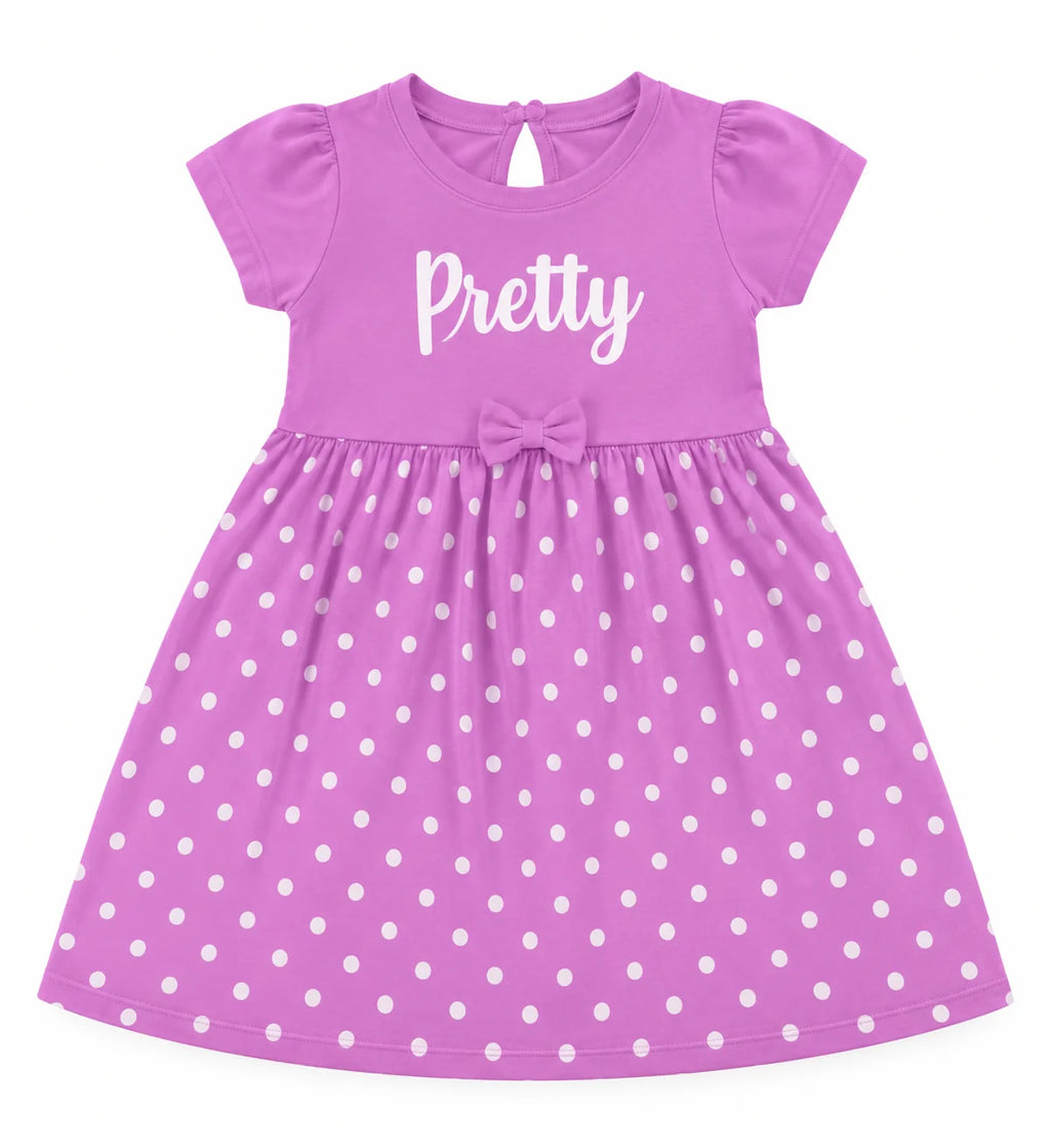 A purple short-sleeve baby dress with white polka dots, featuring the word 'Pretty' printed in white script on the chest and a matching bow at the waist.