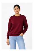 Woman wearing a maroon sweatshirt and light blue jeans on a white background