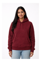 Woman wearing a maroon hoodie on a white background