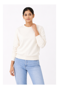 Woman wearing a white sweater and light blue jeans on a white background