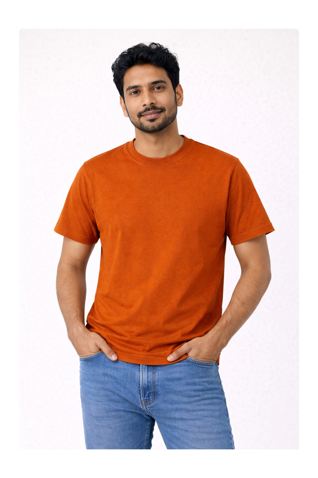 Man wearing an orange t-shirt and blue jeans on a white background