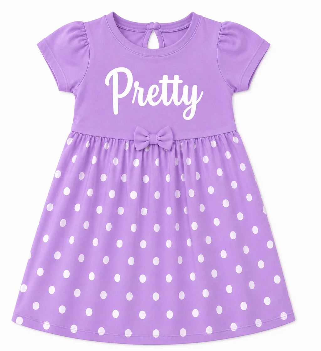 A purple short-sleeve baby dress with white polka dots, featuring the word 'Pretty' in white script across the chest and a matching bow at the waist.
