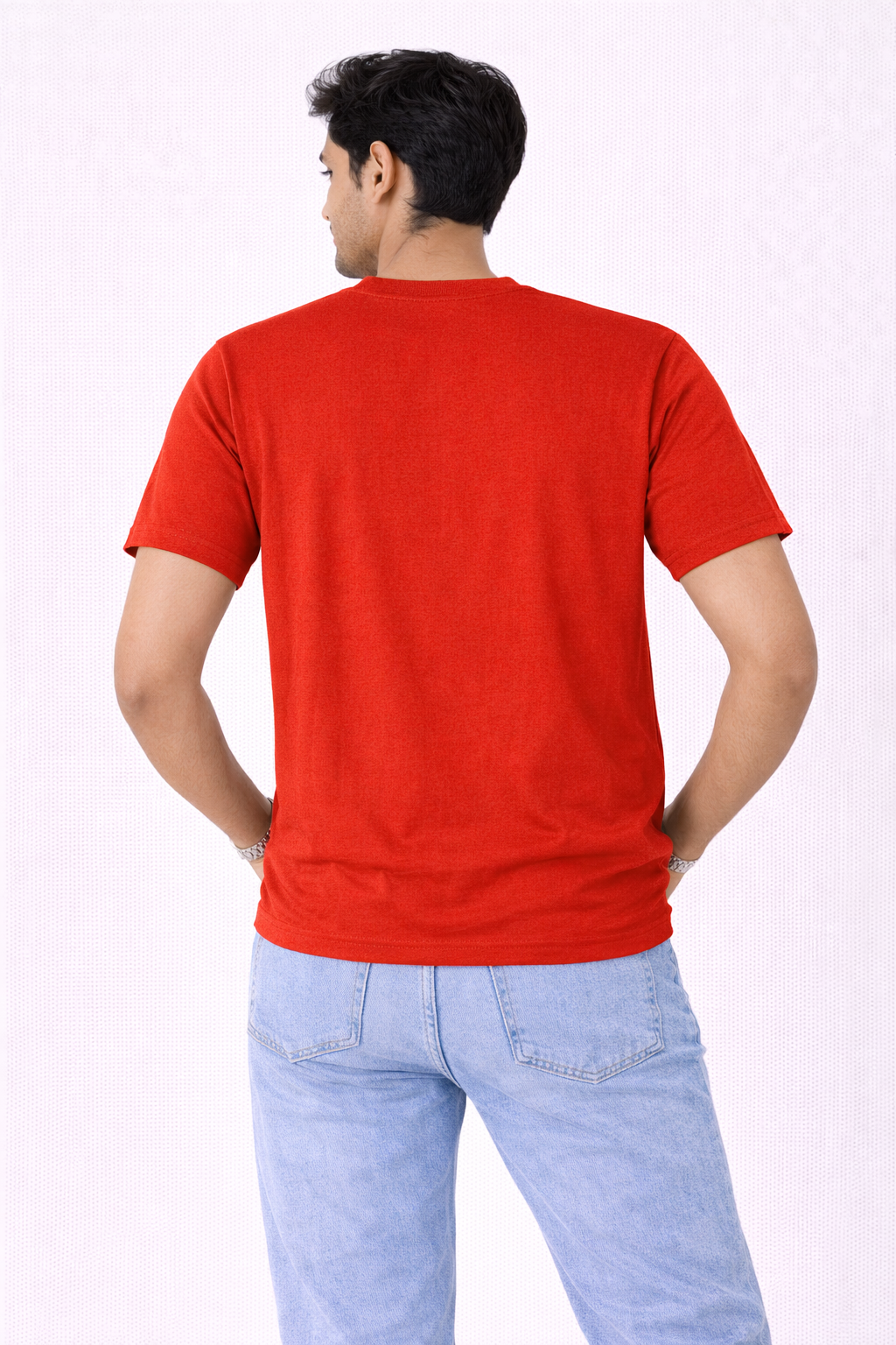 Person wearing a red t-shirt and light blue jeans on a white background