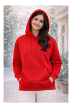 Person wearing a red hoodie with a blurred background