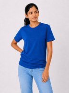 Woman wearing a blue t-shirt and light blue jeans on a white background