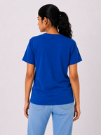 Person wearing a blue t-shirt and light blue jeans on a plain background