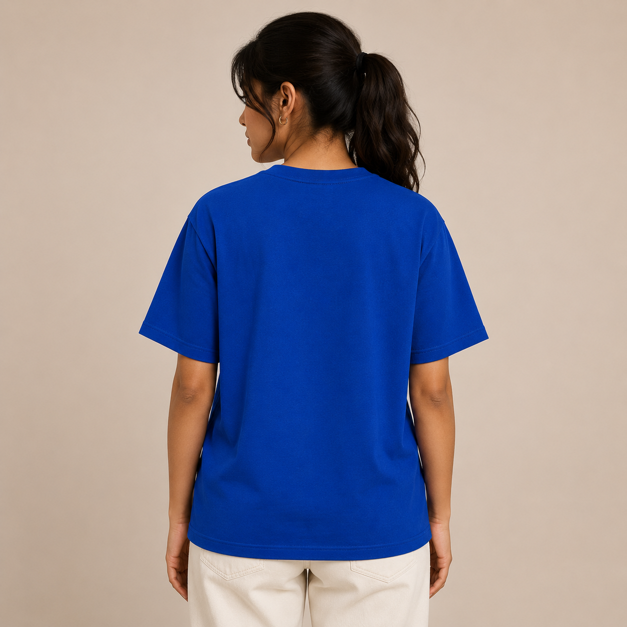 Person wearing a blue t-shirt on a beige background