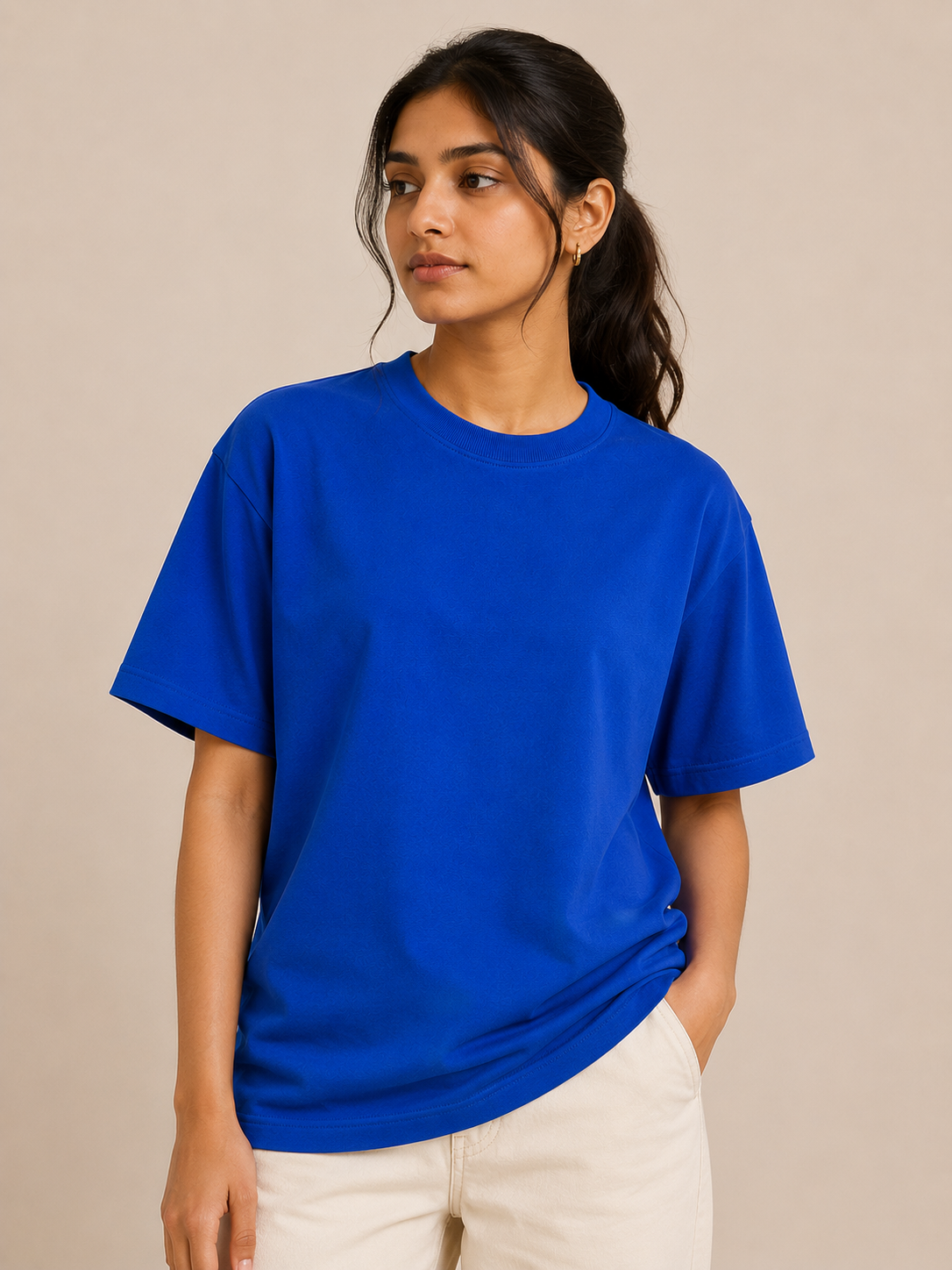 Person wearing a blue t-shirt against a beige background