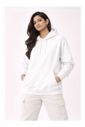 Woman wearing a white hoodie and pants on a light pink background