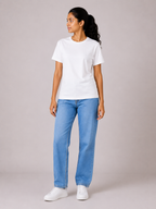 Person wearing a white t-shirt and blue jeans on a plain background
