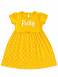 A yellow short-sleeve baby dress with white polka dots and the word 'Pretty' printed in white script across the chest, displayed on a solid white background.
