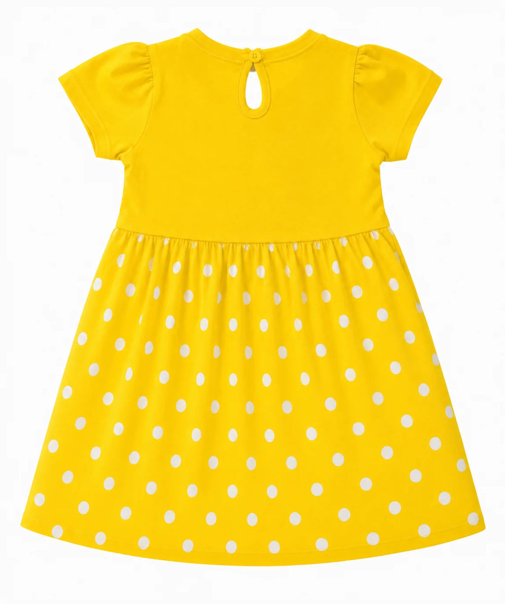 A bright yellow children's dress with white polka dots, featuring short puff sleeves, a keyhole back neckline, and a gathered skirt, shown against a plain white background.