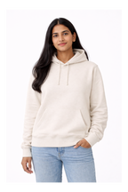 Woman wearing a white hoodie and light blue jeans on a white background