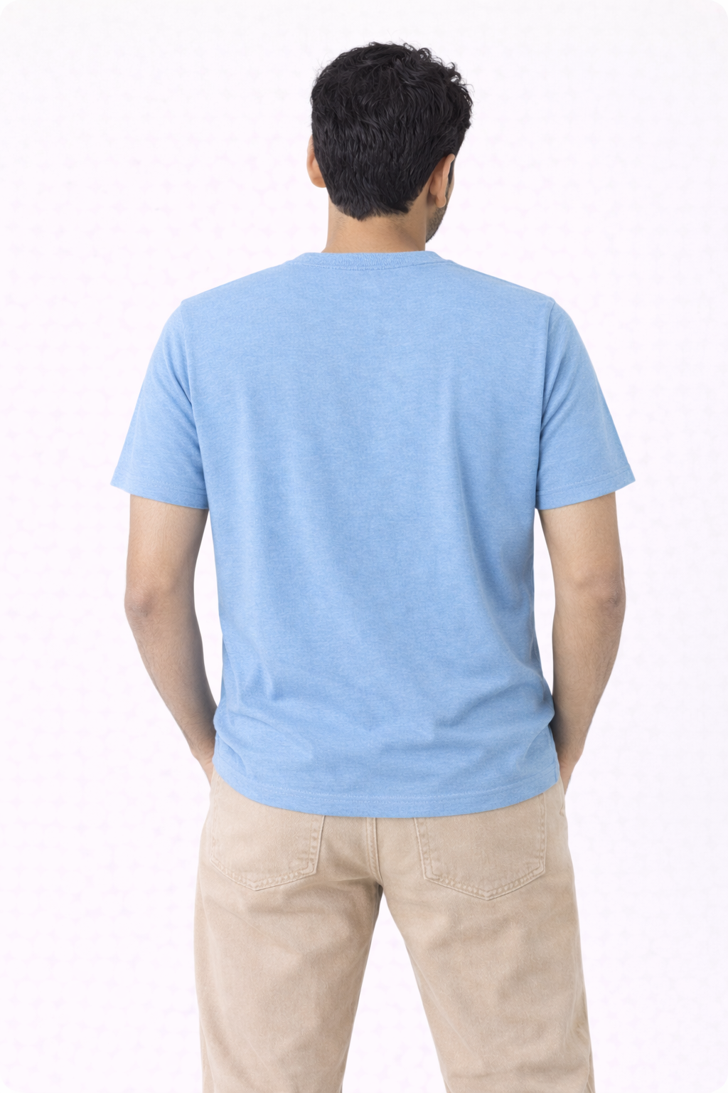 Person wearing a light blue t-shirt and beige pants on a white background